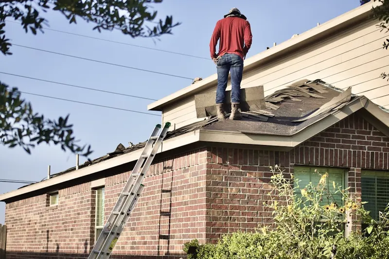 Professional roofer working on a residential roof in Sarasota Springs